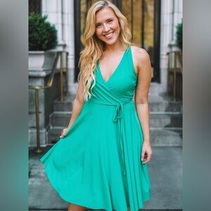 Ashley Graham beyond emerald green, faux wrapped dress